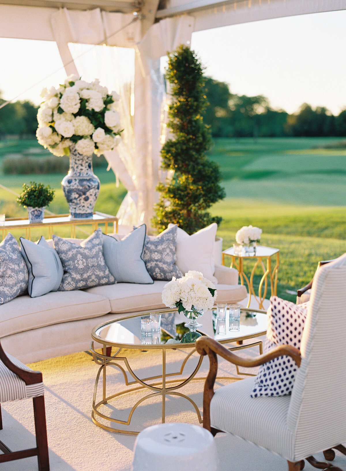 A picture of the couch and floral arrangements of the Onwentsia country club. 