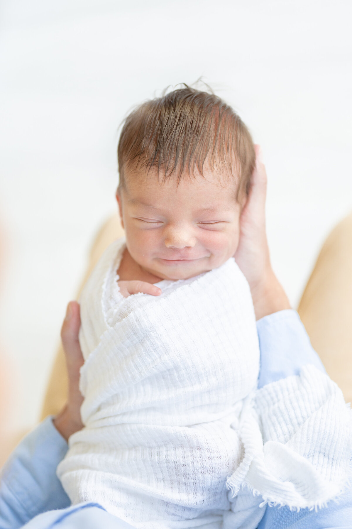 Smiling newborn by Apex newborn Photographer