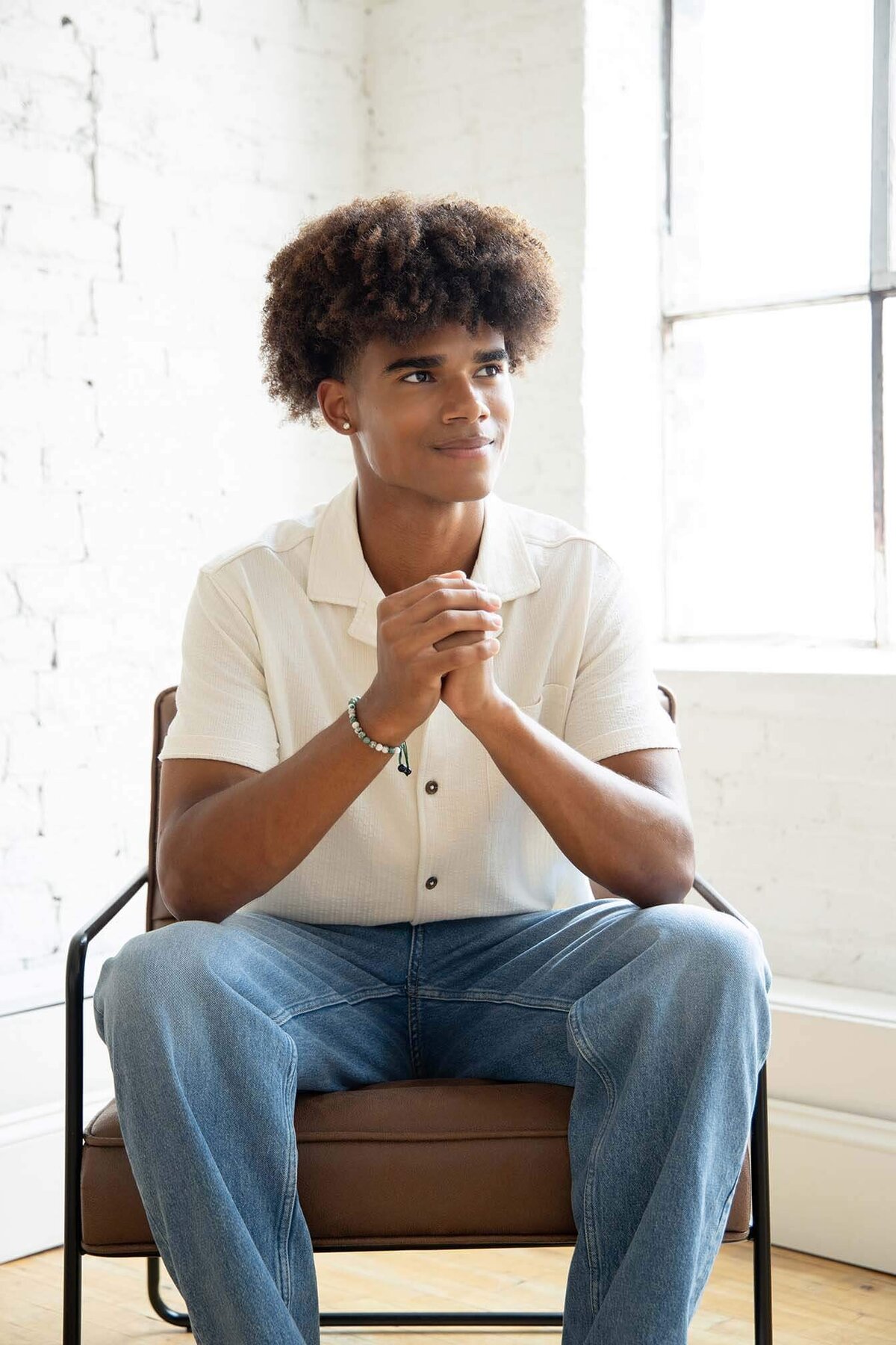 senior-guy-thinking-in-brown-chair