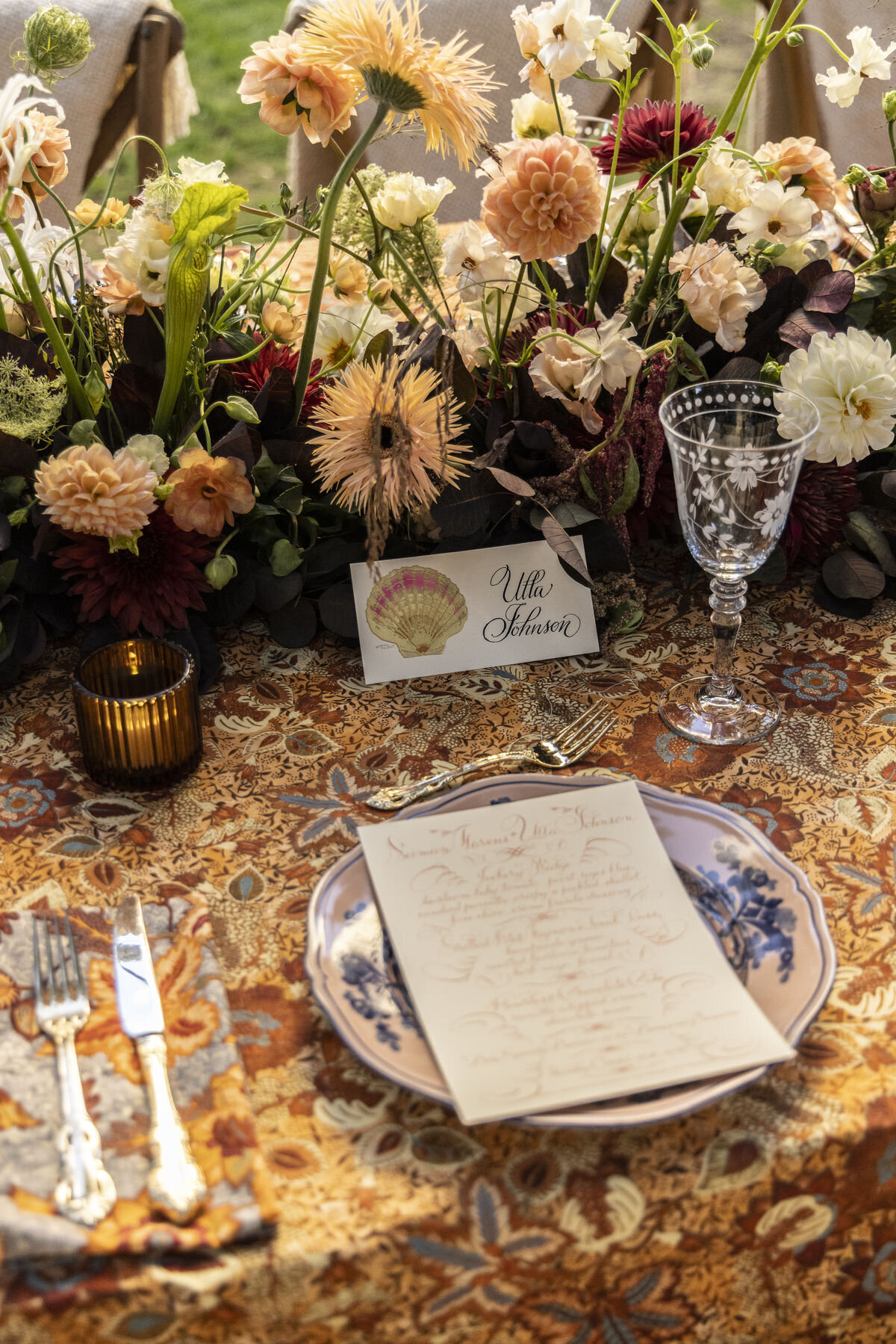 Editorial wedding tablescape with patterned linens and layered paper goods, styled as inspiration for Airlie Gardens receptions