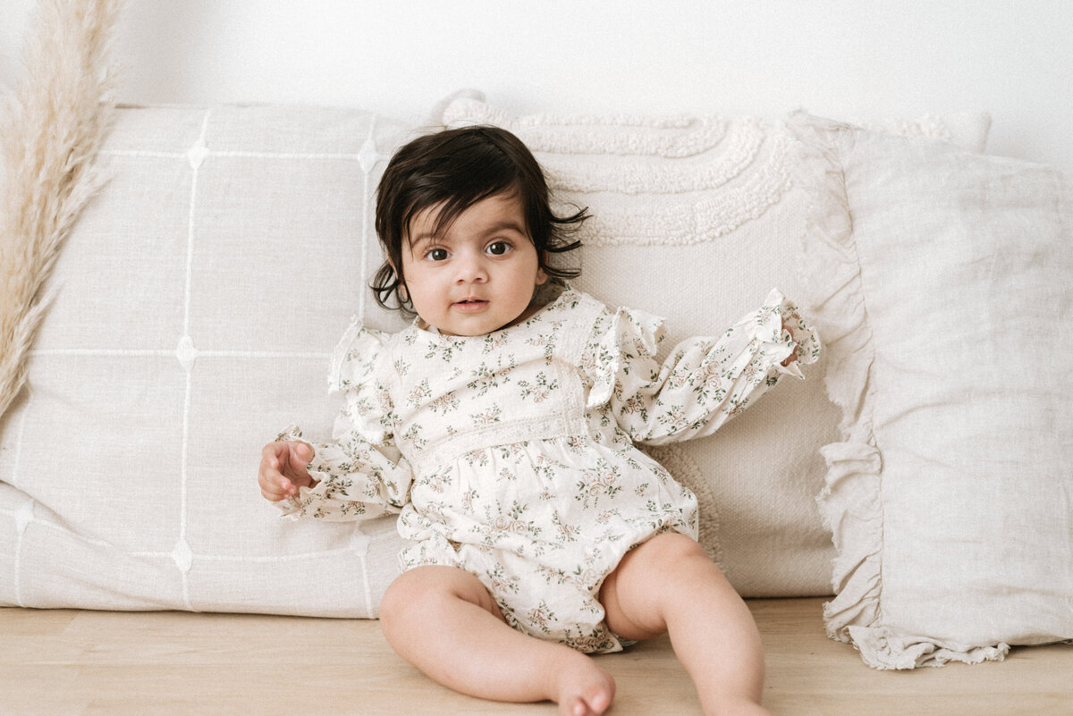 baby sitting on a bench on milestone photoshoot in Billingshurst