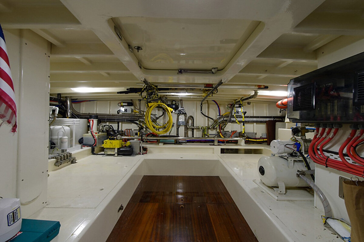 clean, organized engine room with various machinery and pipes mounted on the walls and ceiling