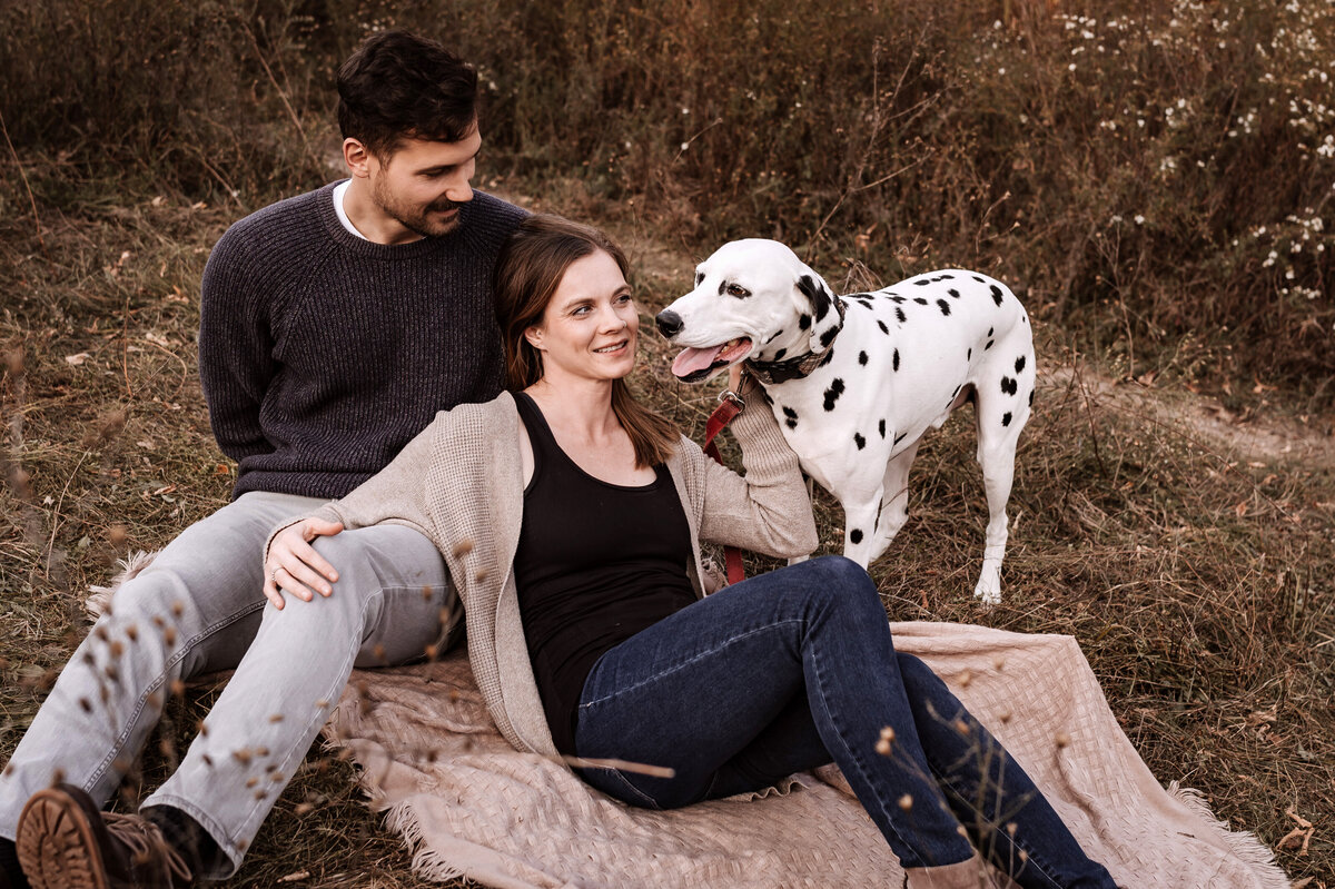 Couple on a blanket with a dog