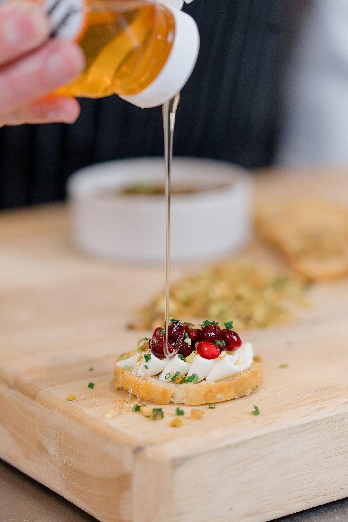 catering business branding photos with a chef drizzling  honey over cranberries on a sweet treat