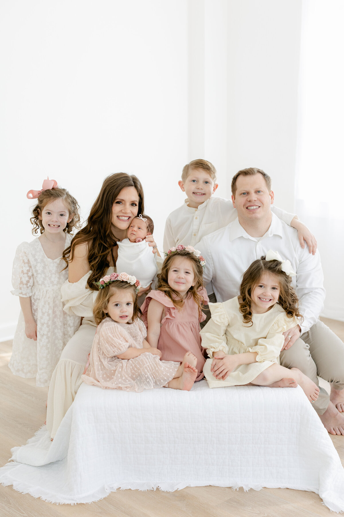 Family of 8 gathered on a bed in Family Photographer South Jersey tara Federico's Haddonfield Studio