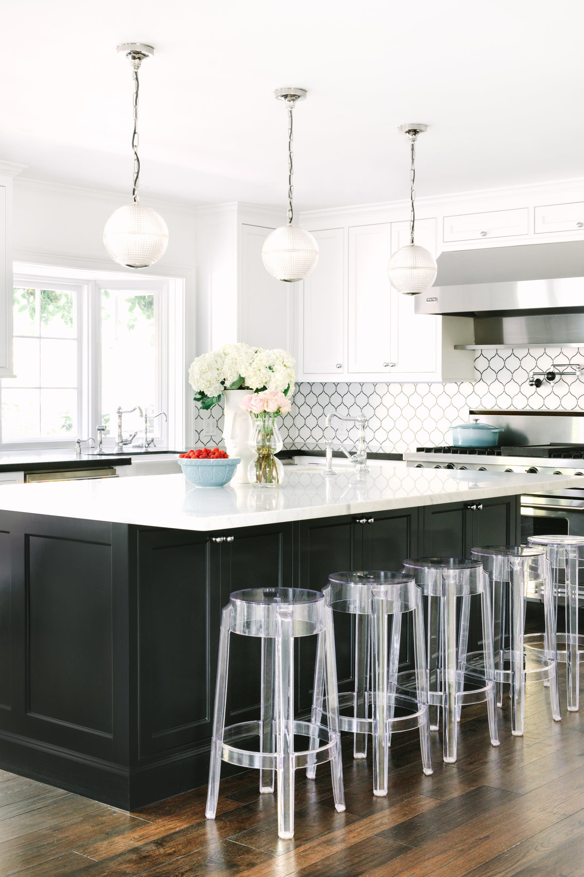Classic, white kitchen with black island and Carrara marble counter