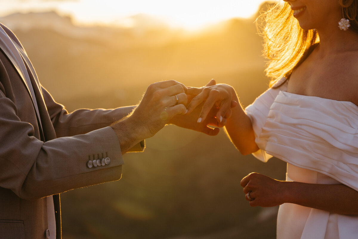 romantic couple wearing wedding ring with dramatic Dolomites backdrop