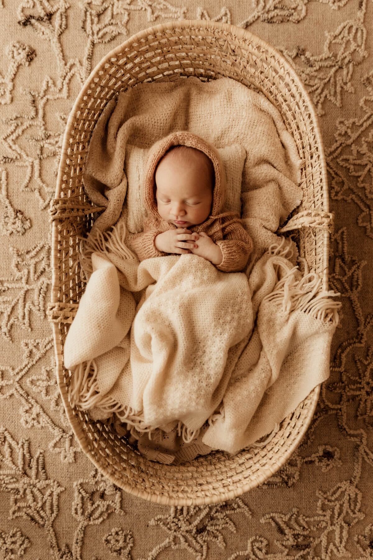 Newborn baby boy sleeping in a basket for a lifestyle newborn session in OKC.