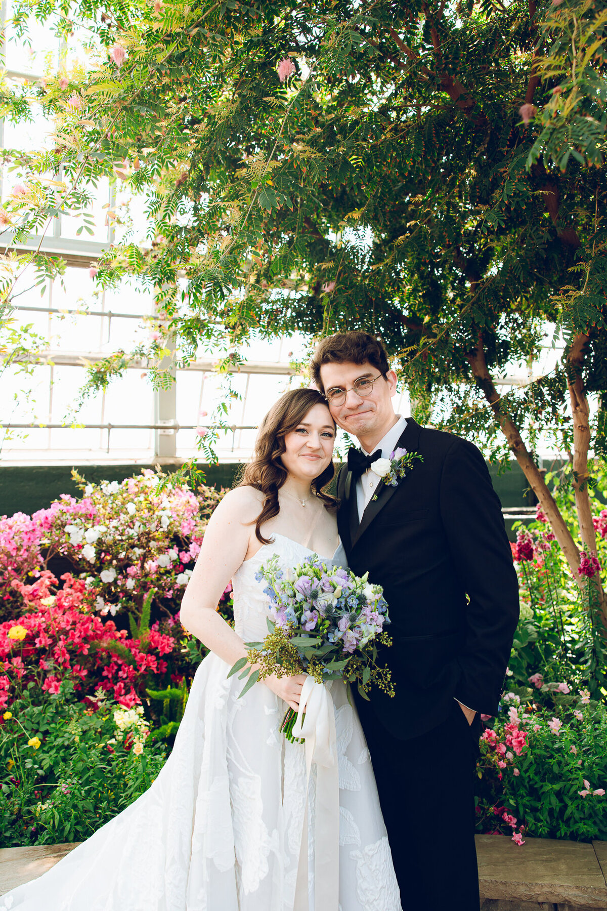 A couple poses on their wedding day at the Garfield Park Conservatory in Chicago