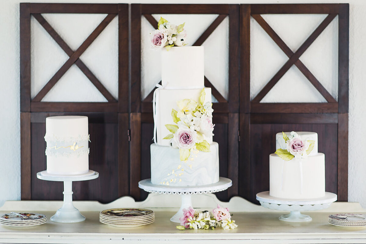 Classic wedding cake inspiration, cake table in front of vitage window, by Yvonne's Delightful Cakes, classic cakes & desserts in Calgary, Alberta, featured on the Brontë Bride Vendor Guide.