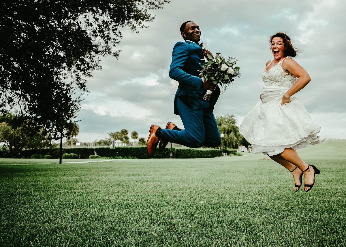 Newlywed couple jump for joy after ceremony at Tanner Hall
