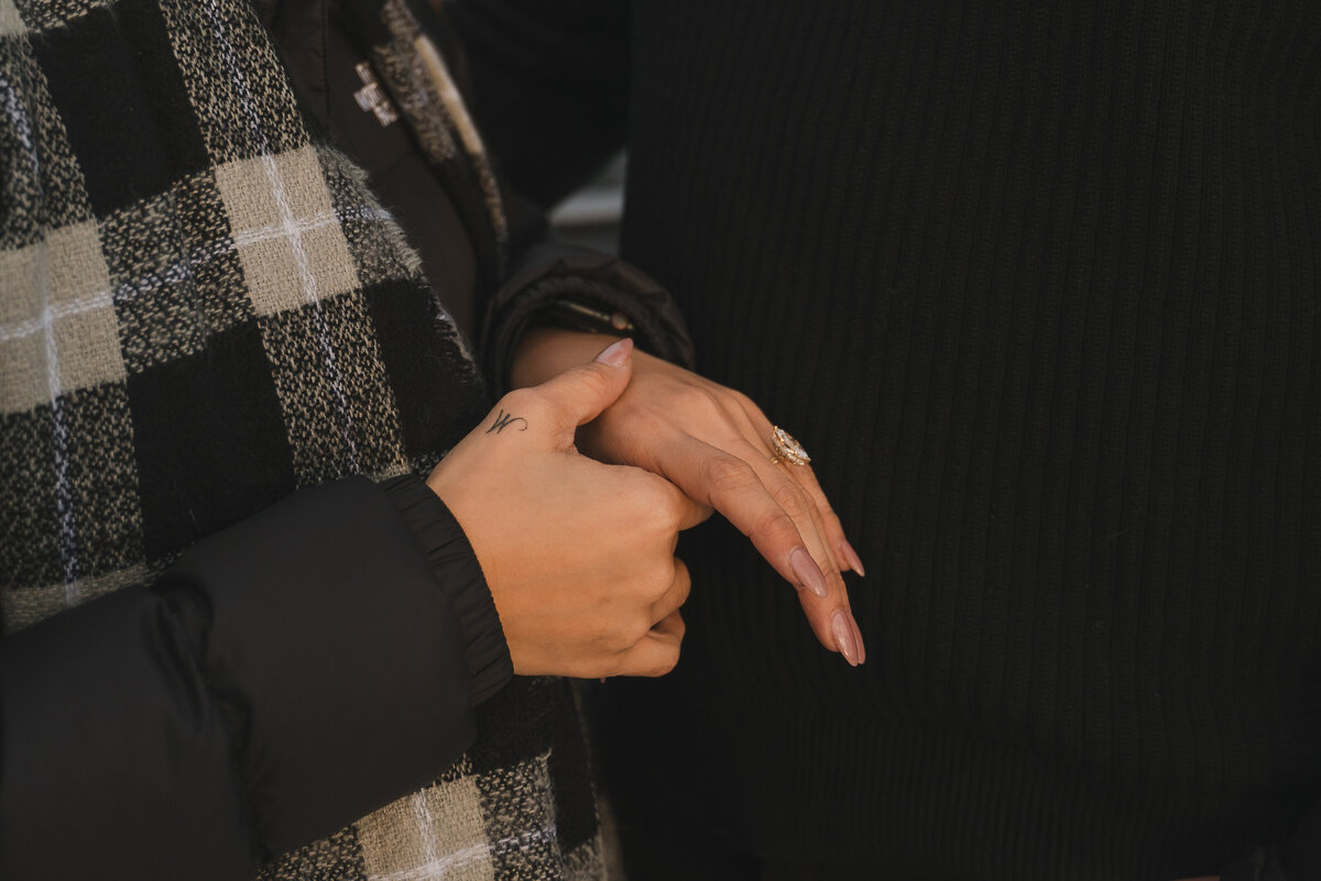 Close-up of woman’s hand showing new ring after proposal in Banff.