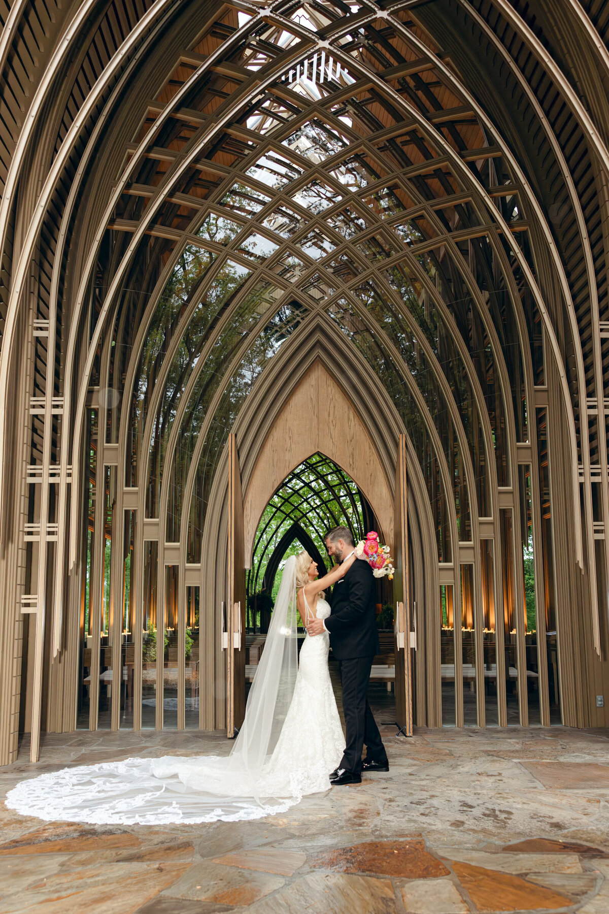 A wedding photo of the bride and groom on the alter at Anthony's Chapel in Hot Springs Arkansas