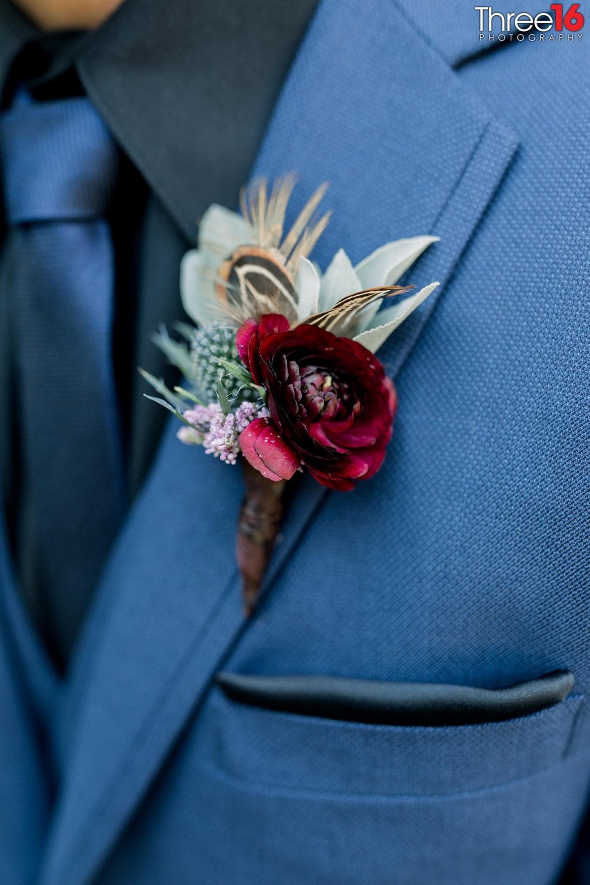 Beautiful boutonniere on Groom's blue suit