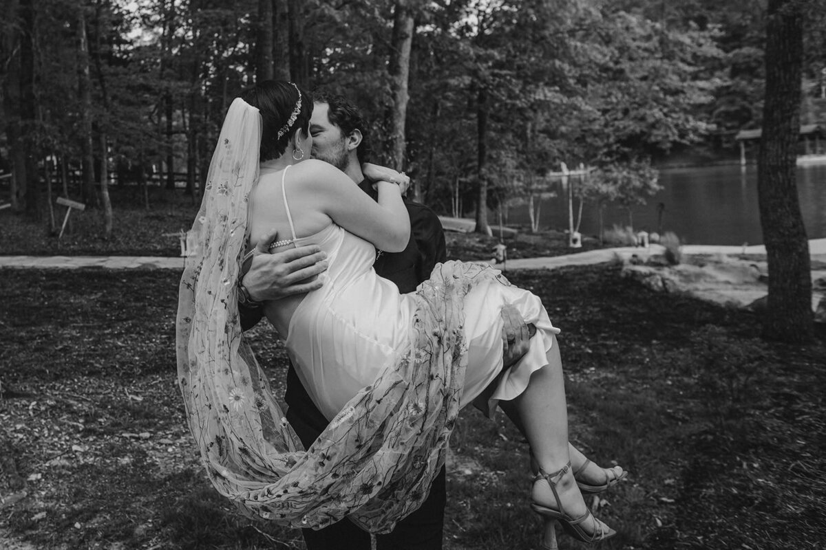 A person holding their partner up as they kiss