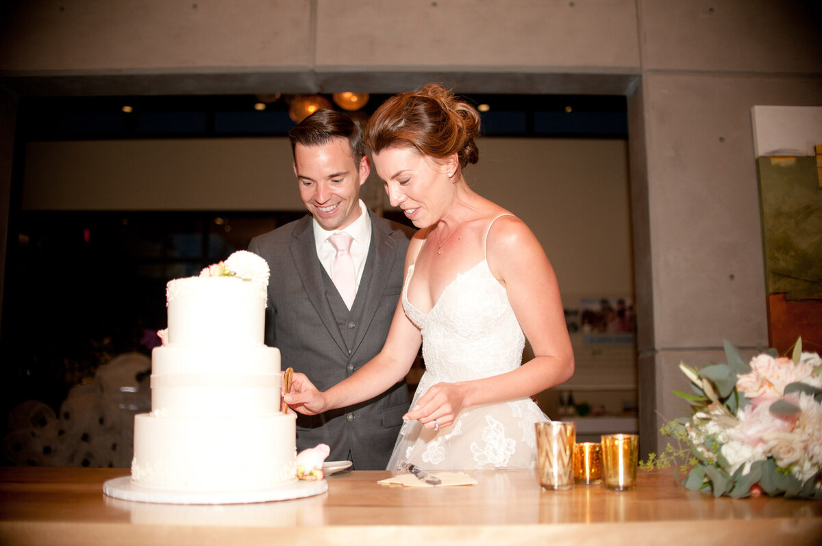 bride and groom cutting the dream cakes a ponzi winery wedding