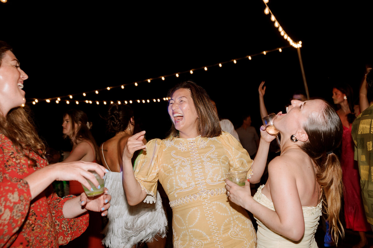 Wedding guests dancing and enjoying themselves at the after-party, captured in a fun and energetic moment by Kate Winters Photography.