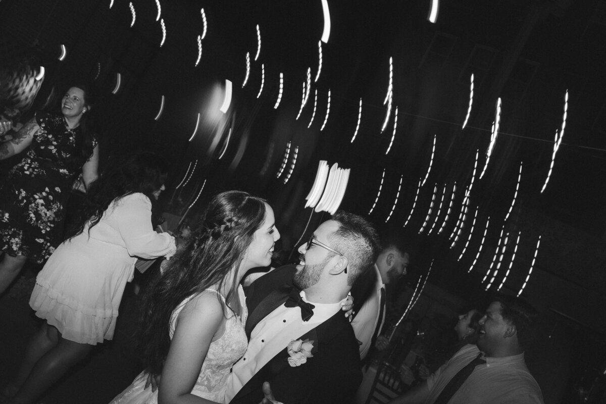 Bride and groom kissing at their wedding reception, taken by Asheville Wedding Photographer Simon Anthony Photography