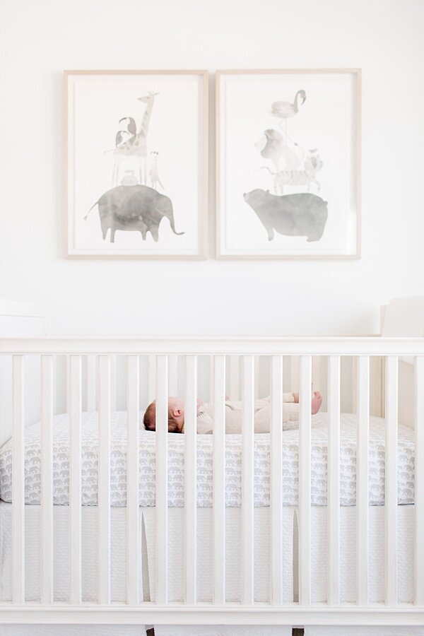baby laying in white crib by DC Newborn Photographer Emily
