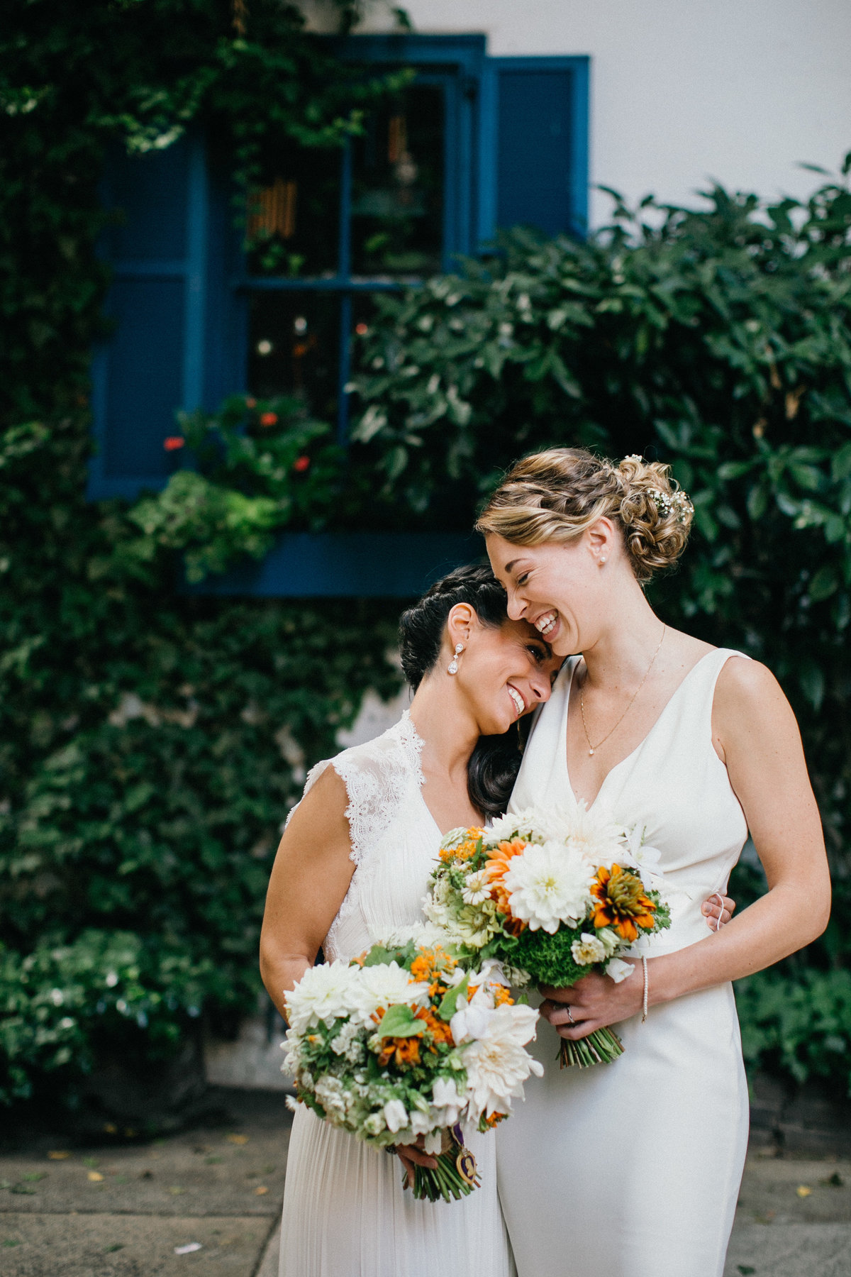 Two brides photographed in Old City, Philadelphia before their wedding.