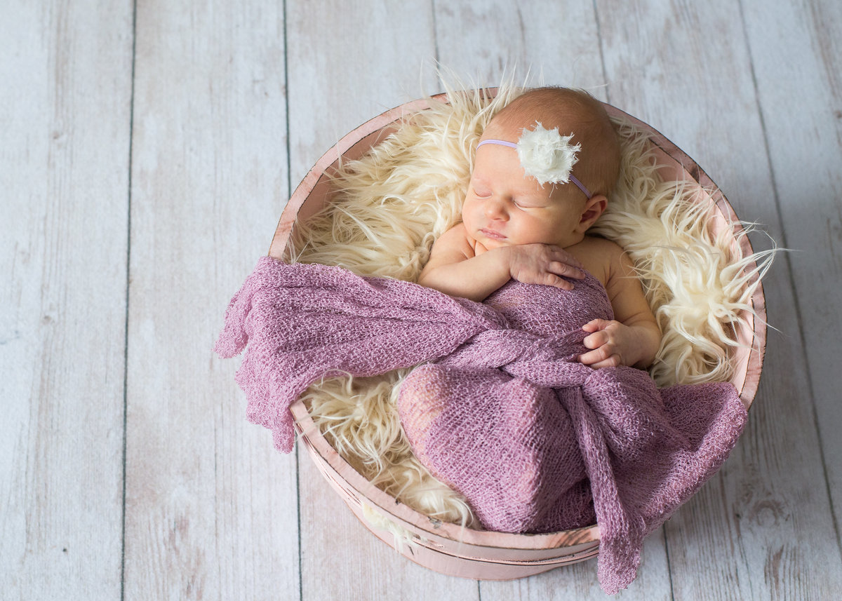 girl newborn photo is pink basket