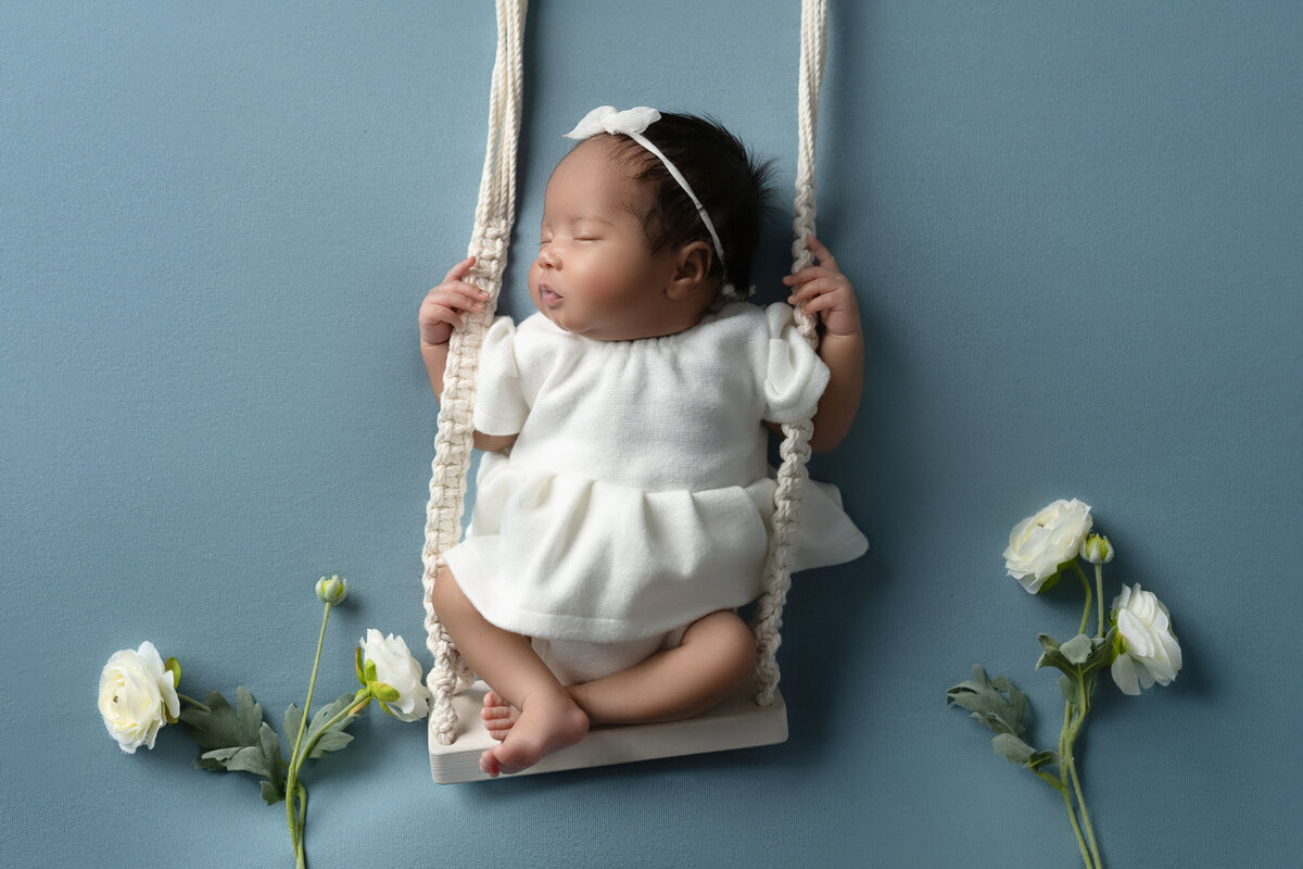 Newborn baby swing white flowers Lakeway professional photographer