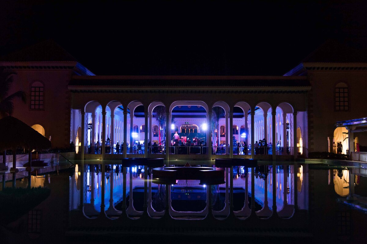 The Paradisus Palma Real Resort Meeting and Event Space at night. The courtyard is lit up with blue lights.