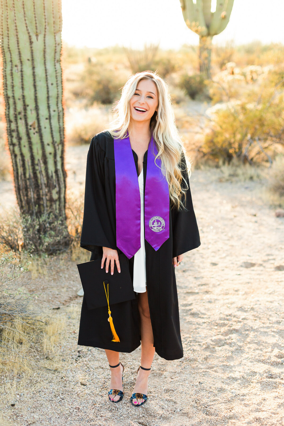 college senior girl in cap and gown graduating from Grand Canyon University