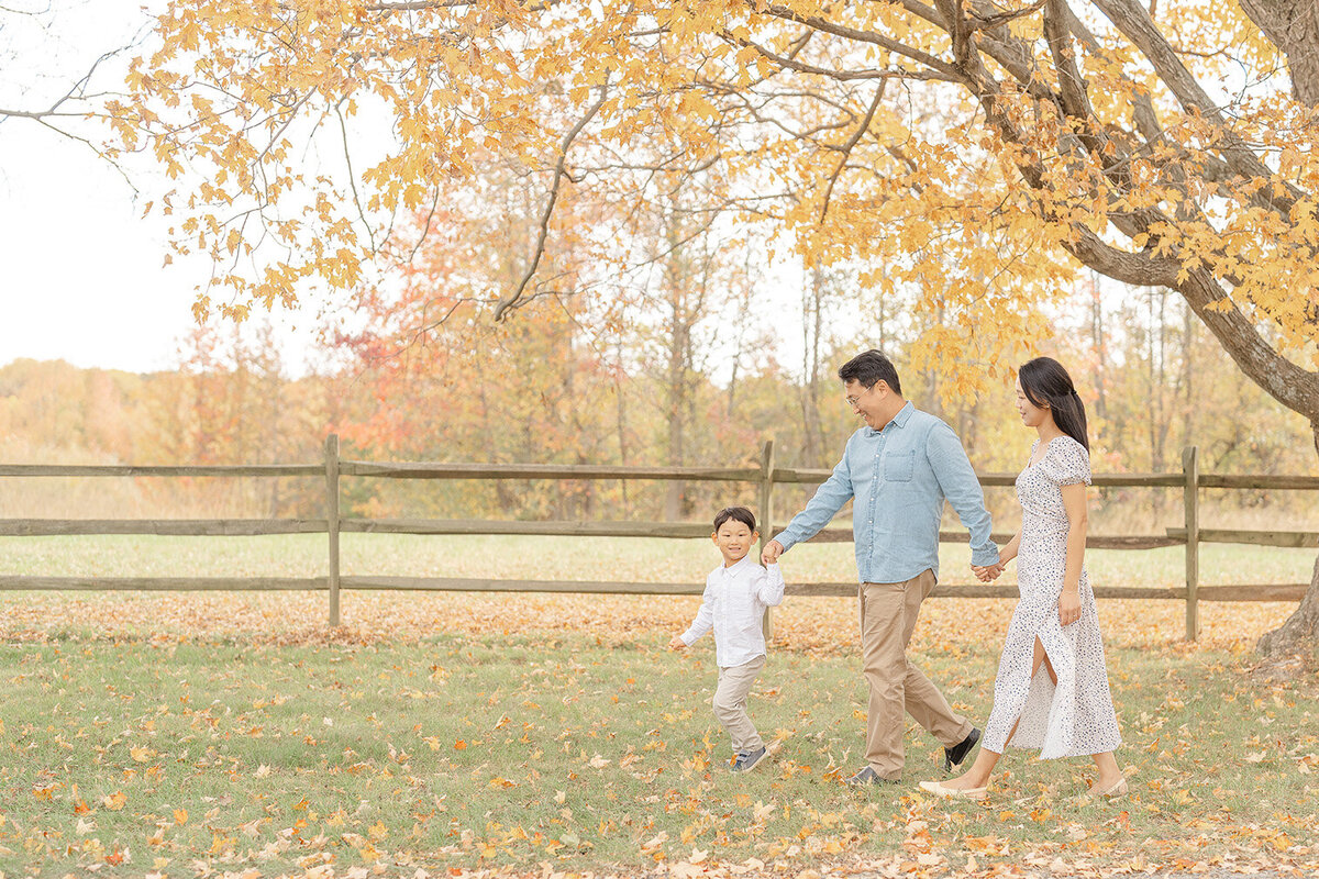 Family of 3 walking during Northern Virginia fall mini session