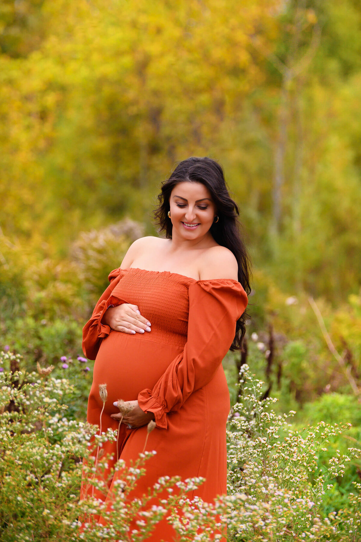 pregnant woman outdoors for her fall maternity session in Burlington, ON