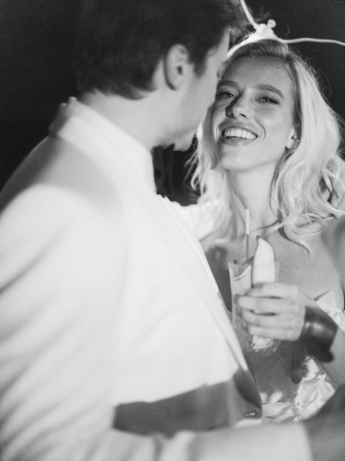 Candid moment of a bride enjoying her wedding party, captured by a luxury destination wedding photographer