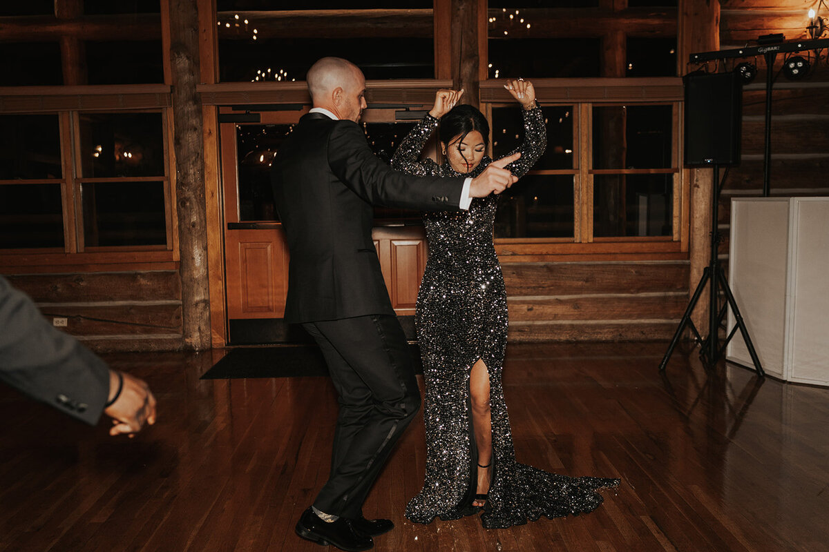 Bride and groom have fun dancing  at their wedding reception in Evergreen Colorado.