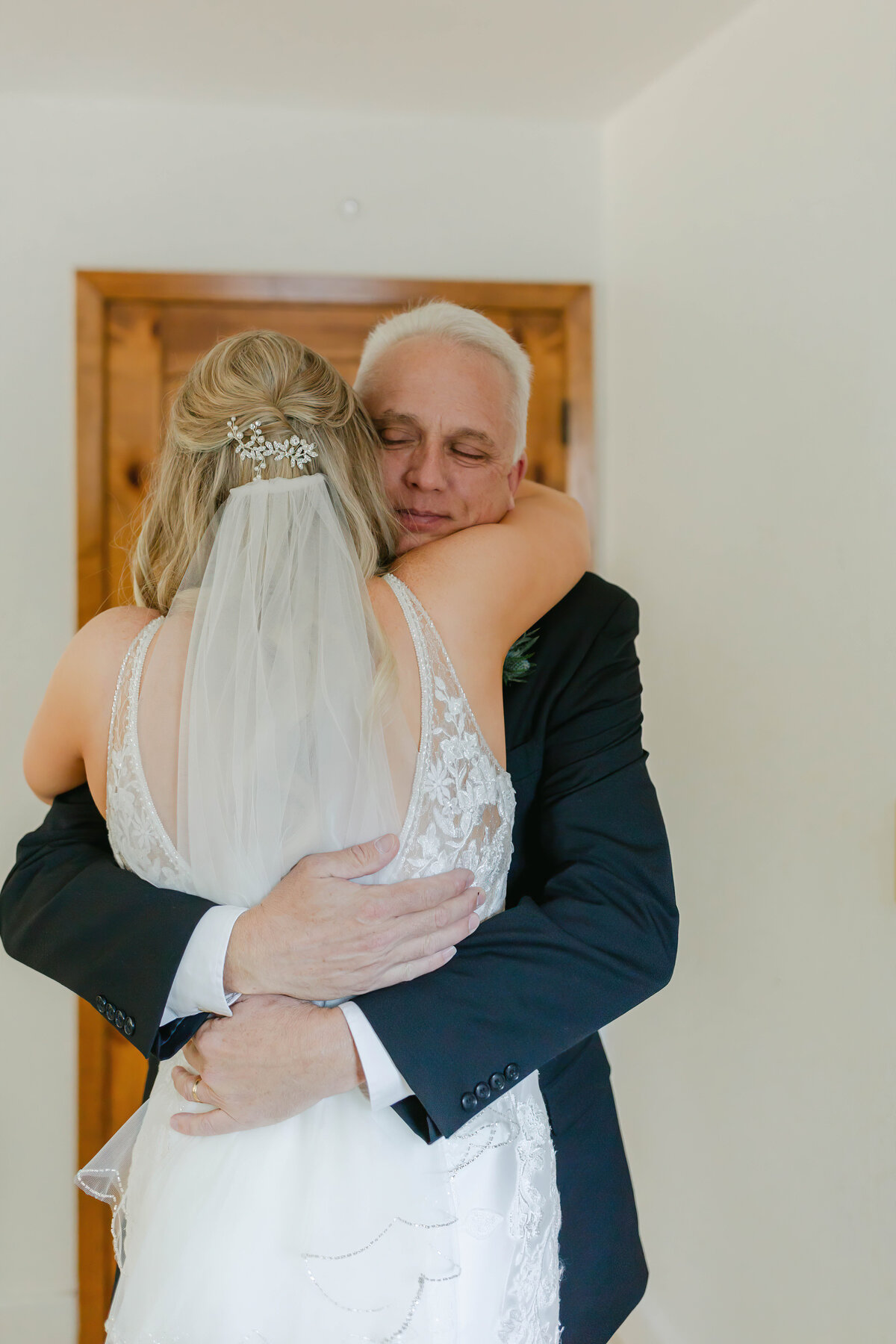 father hugging the bride