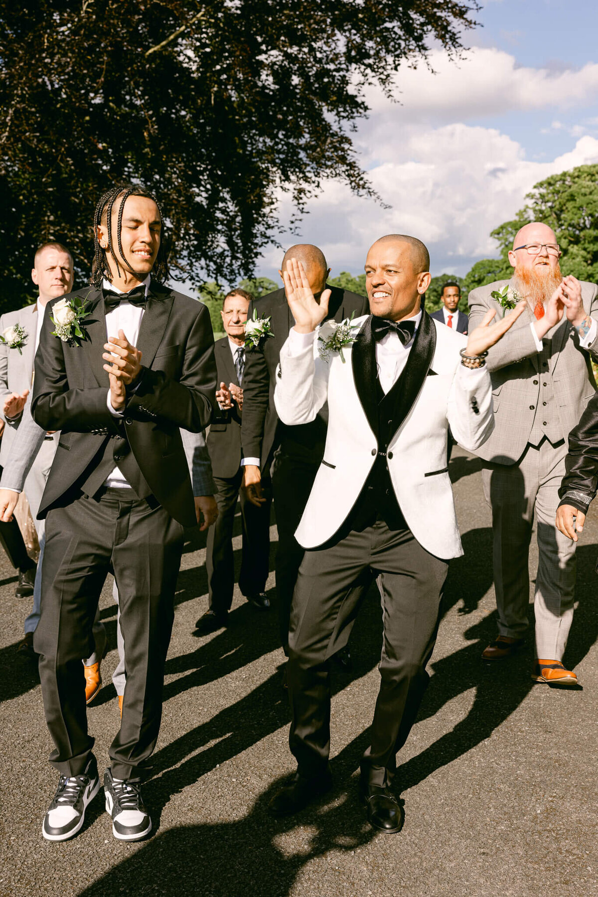 A wedding photo of the groom celebrating with his groomsmen at Luttrellstown Castle in Ireland