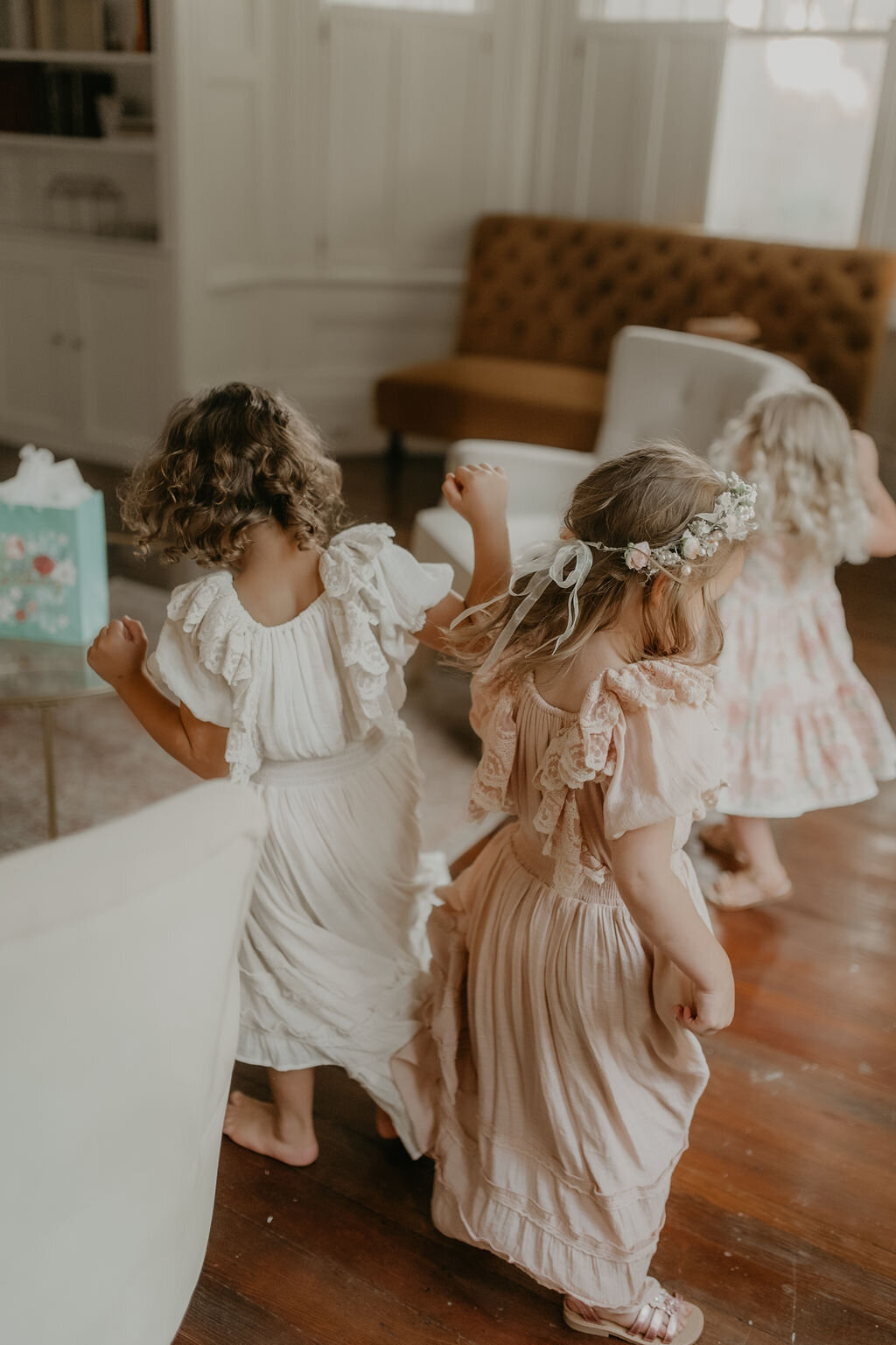 Excited bridesmaids in matching robes, preparing for a Christ-centered wedding day with joyful anticipation, planned by Grace-Filled Gathering Co.