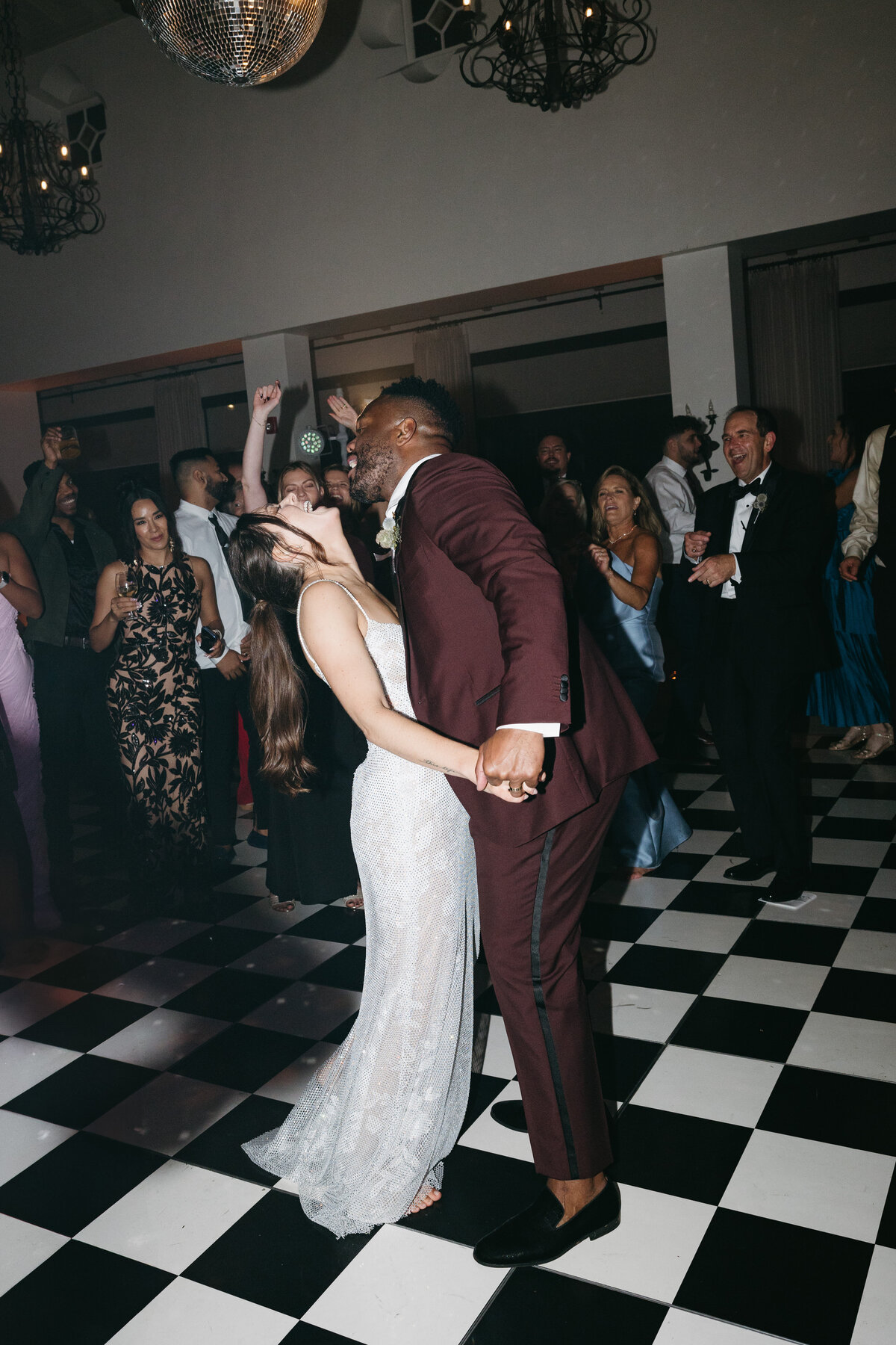 Dance floor moments of the bride and groom having fun, beautifully captured by a La Jolla wedding photographer.