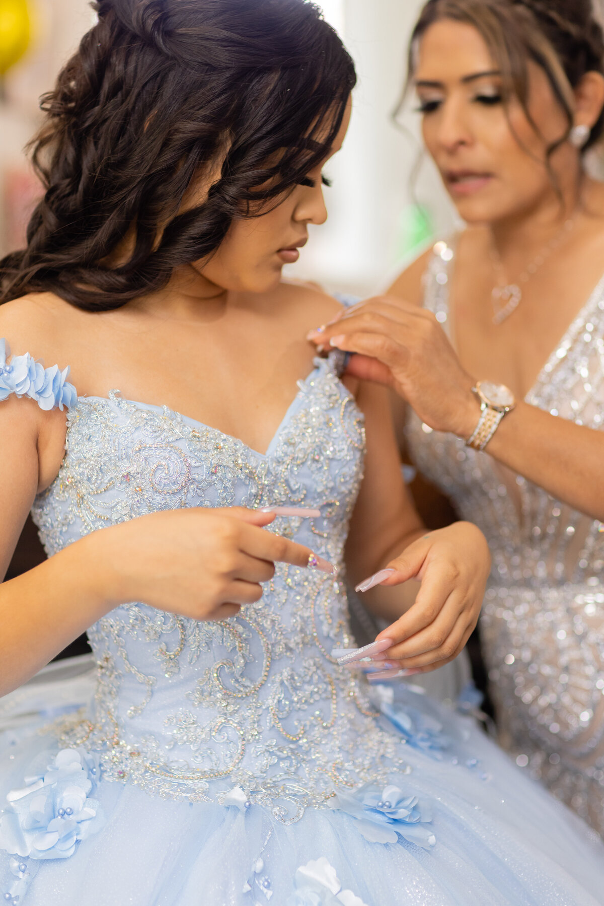 Victoria looked absolutely stunning in her quinceañera gown, captured in a moment of quiet reflection.