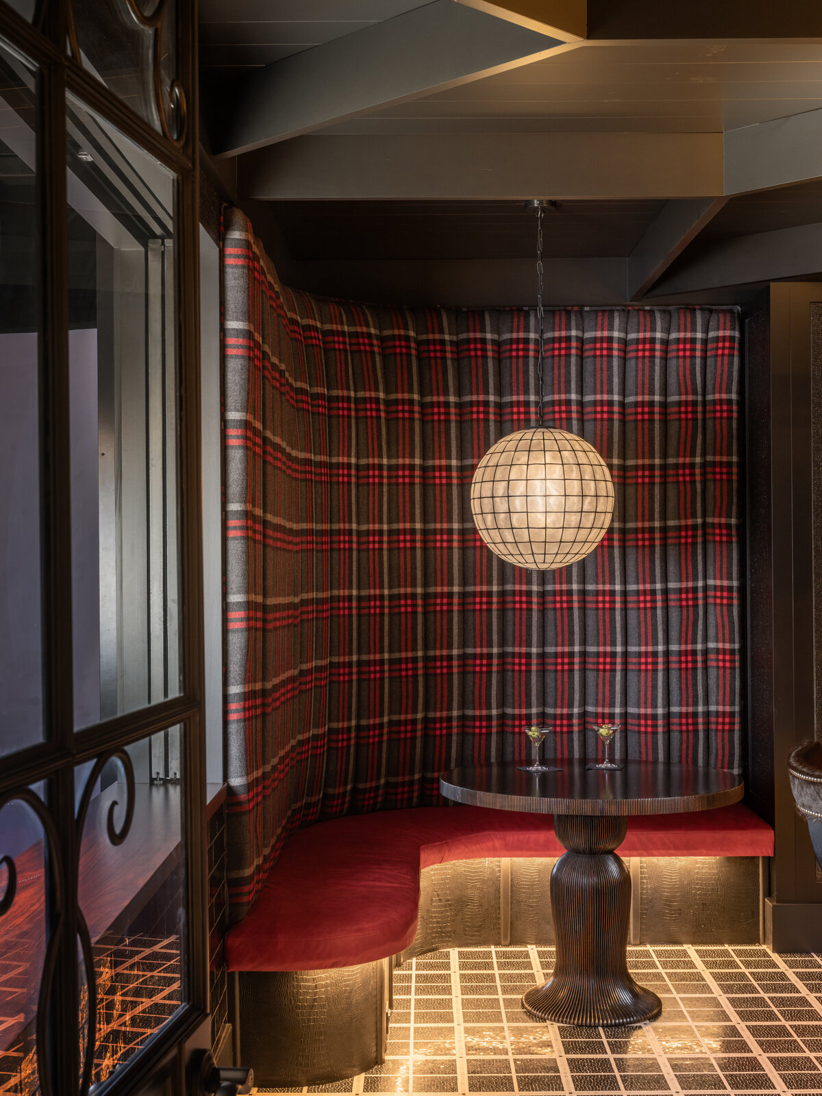 bar table with red plaid wall paper wall