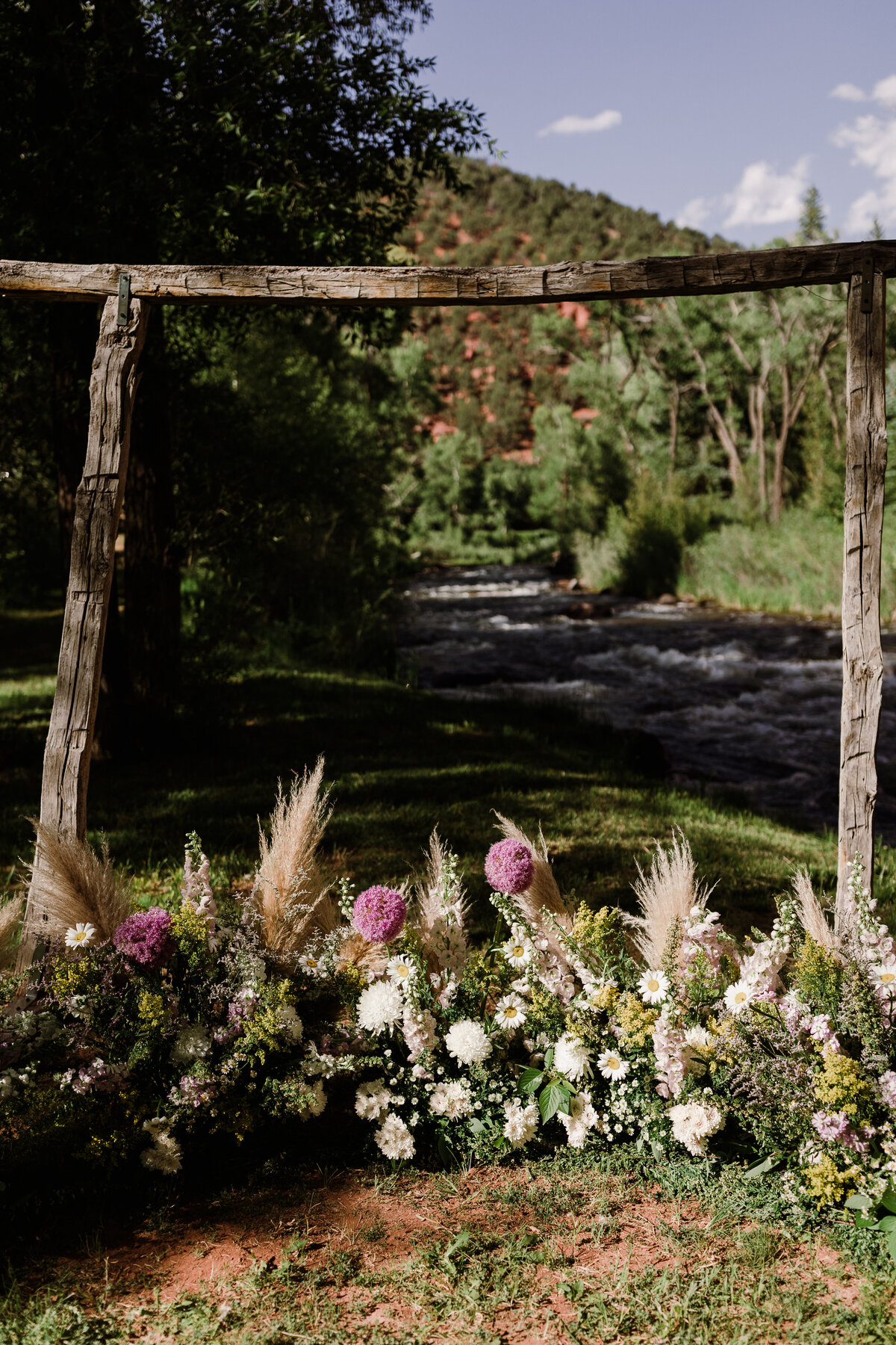 Floral arrangement on the ground at Dallenbach Ranch Colorado Wedding