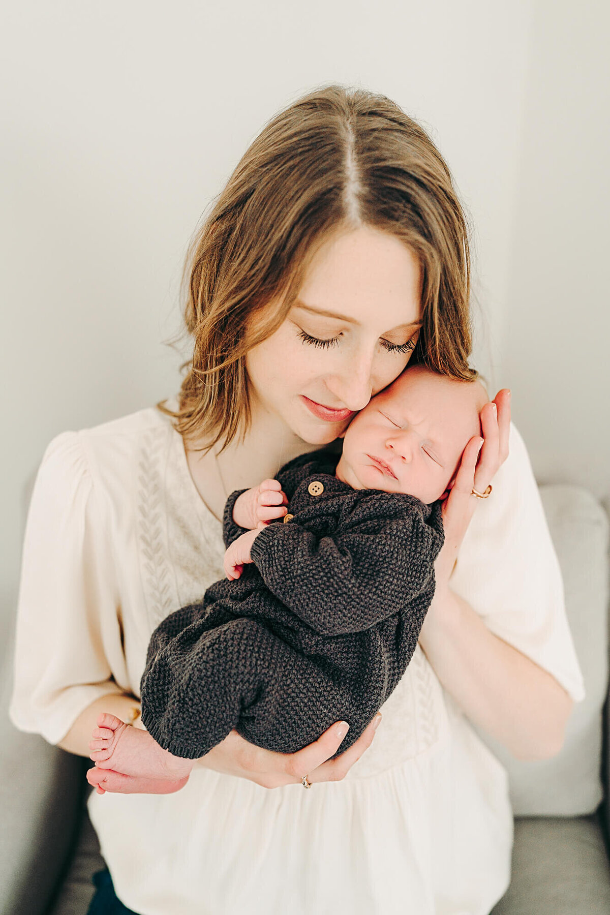 mom nuzzles baby during newborn session in jackson missouri