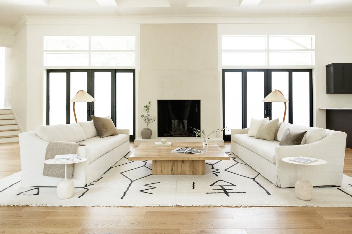 house-franc-toro-canyon-westlake-remodel-renovation-living-room-plaster-fireplace-slipcover-sofas-oak-wood-coffee-table-patina-vintage-caprani-floor-lamp-natural-light-historic-neighborhood-austin-texas