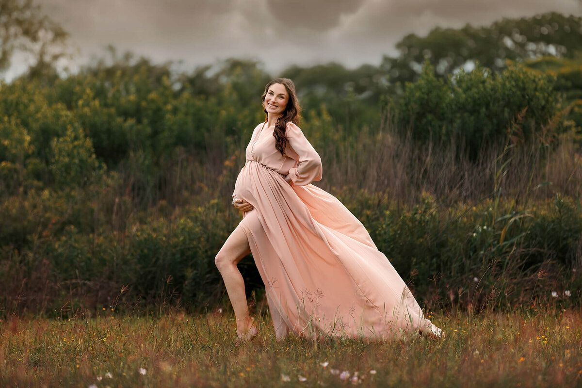 Gorgeous maternity session with beautiful momma wearing  a long nude colored dress in Houston, TX.