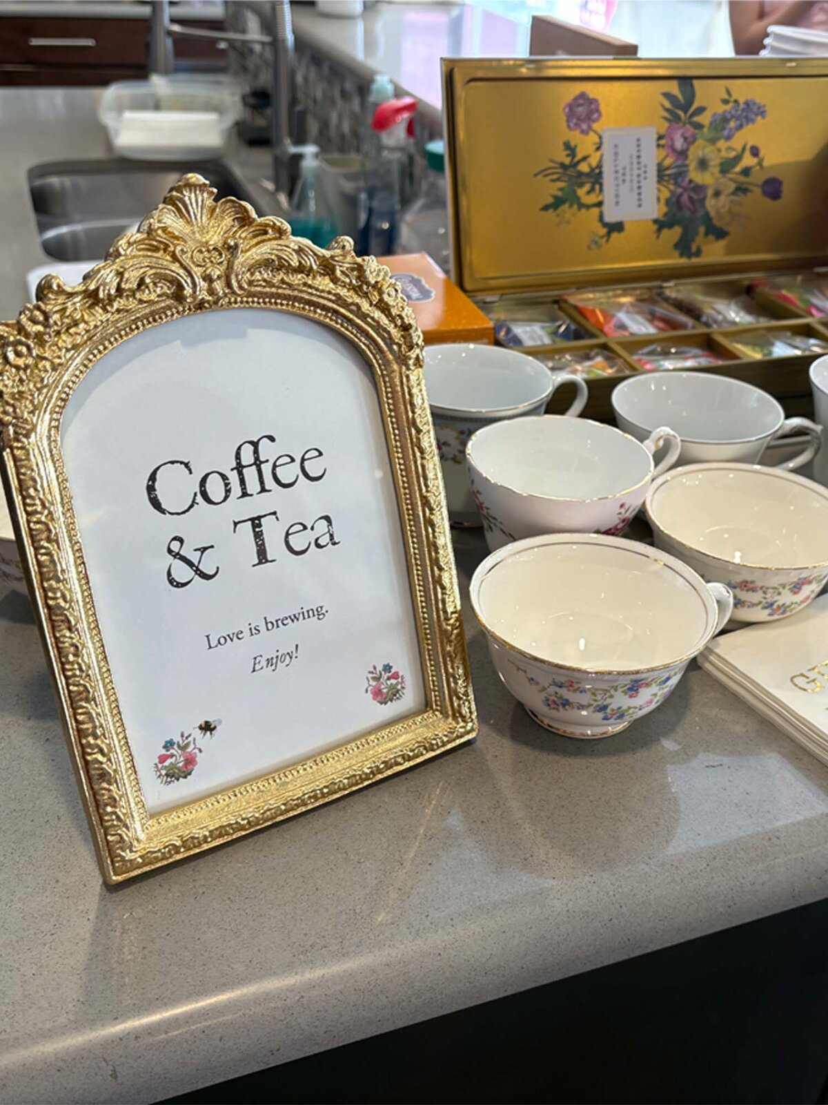 Gilded frame with custom designed event sign. From top to bottom: coffee & tea, love is brewing, enjoy!