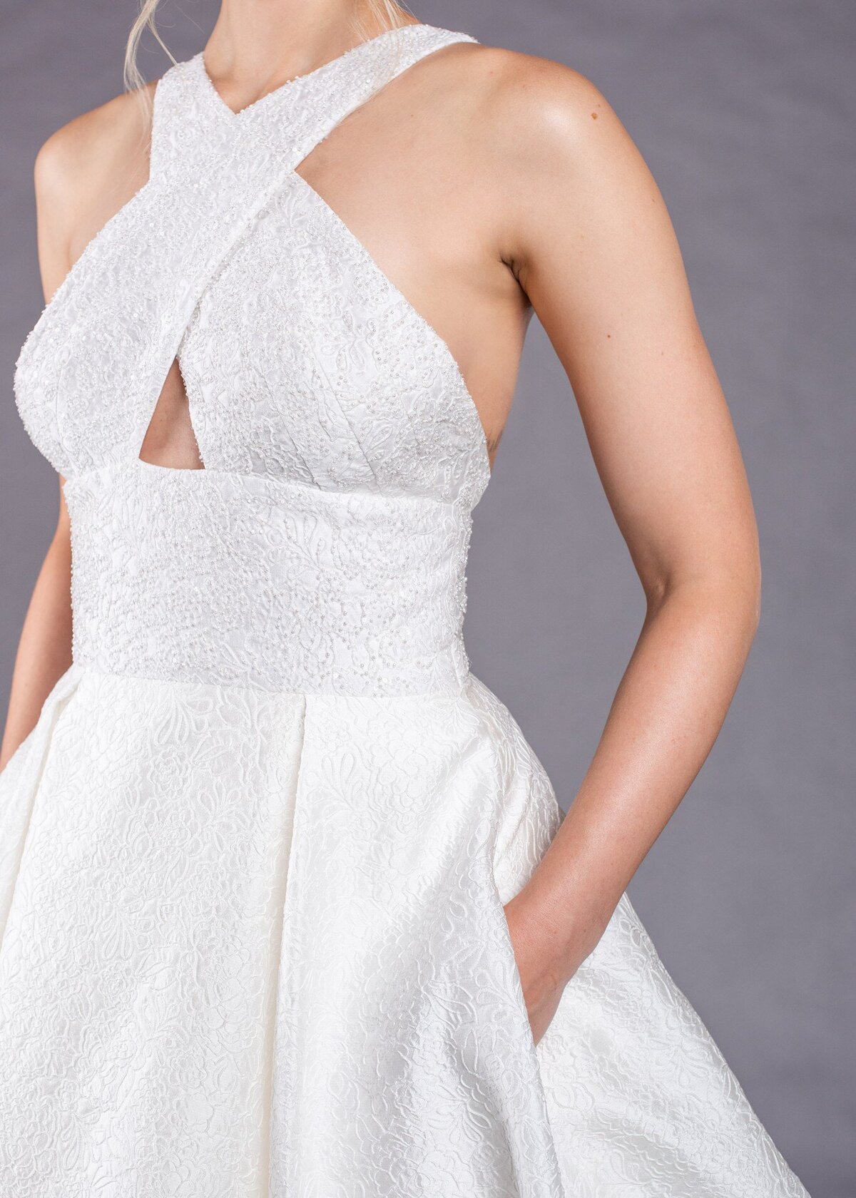 Besides being a wedding dress with pockets, the textured fabric is beaded on the bodice for an added subtle sparkle.