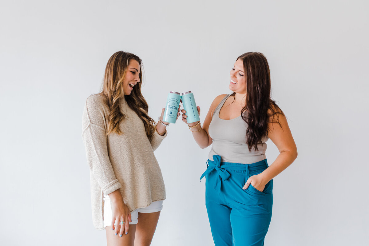 North Augusta studio branding shoot with two girls and cups with augusta branding photographer