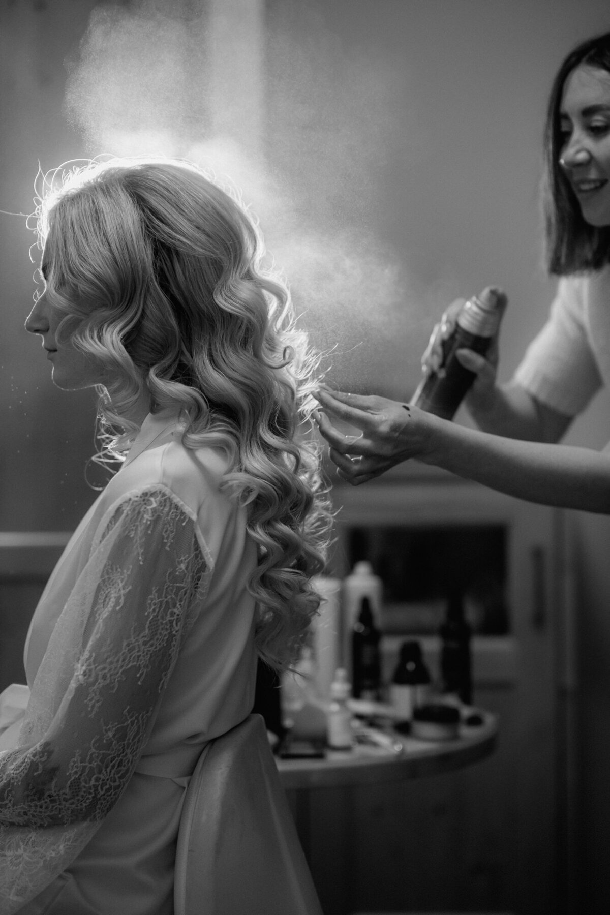 Black and white moment captured during bridal hairstyling.