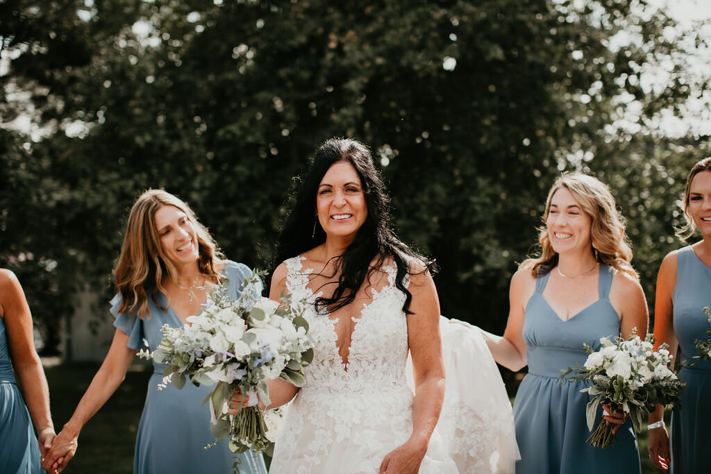 A bride and her bridesmaids in blue