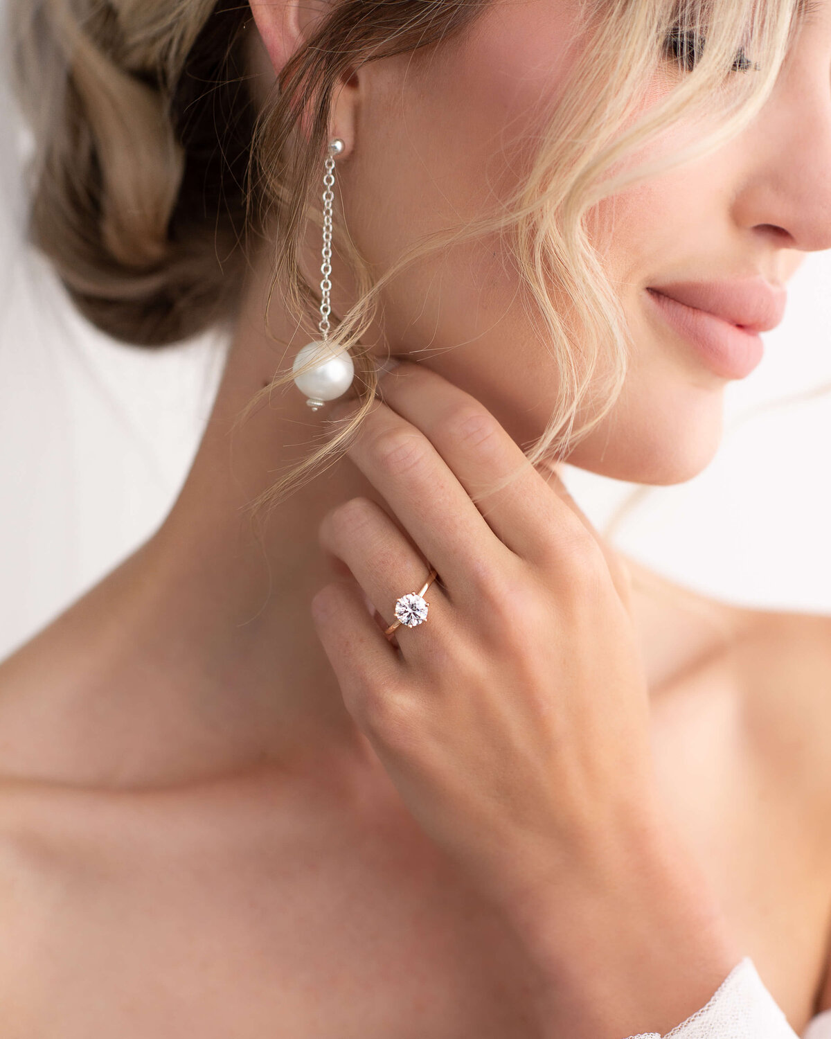 Ottawa wedding photography showing a closeup of a Stor by Margot engagement ring and pearl drop wedding earrings