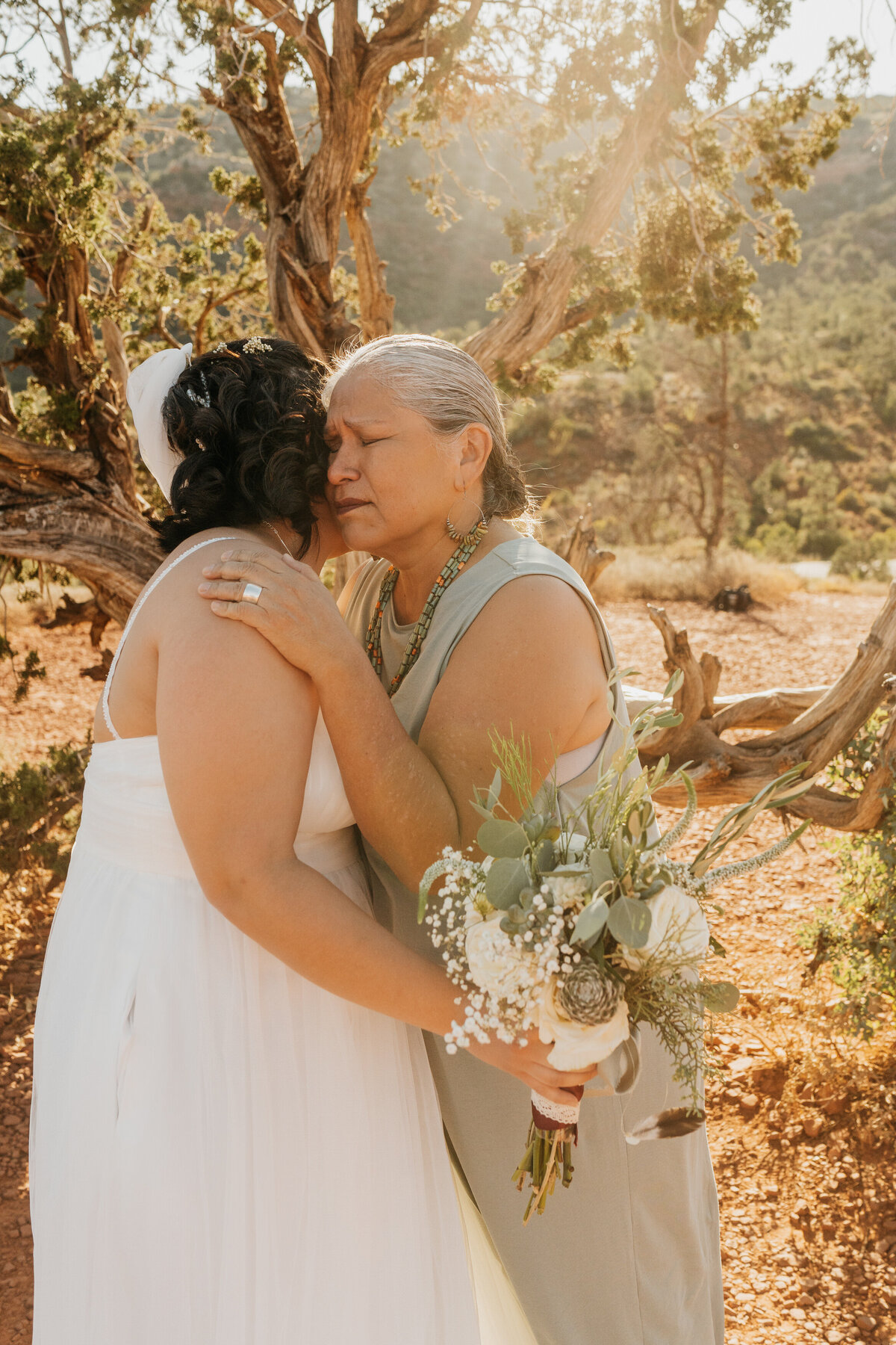 A person hugging a newlywed after their wedding ceremony 