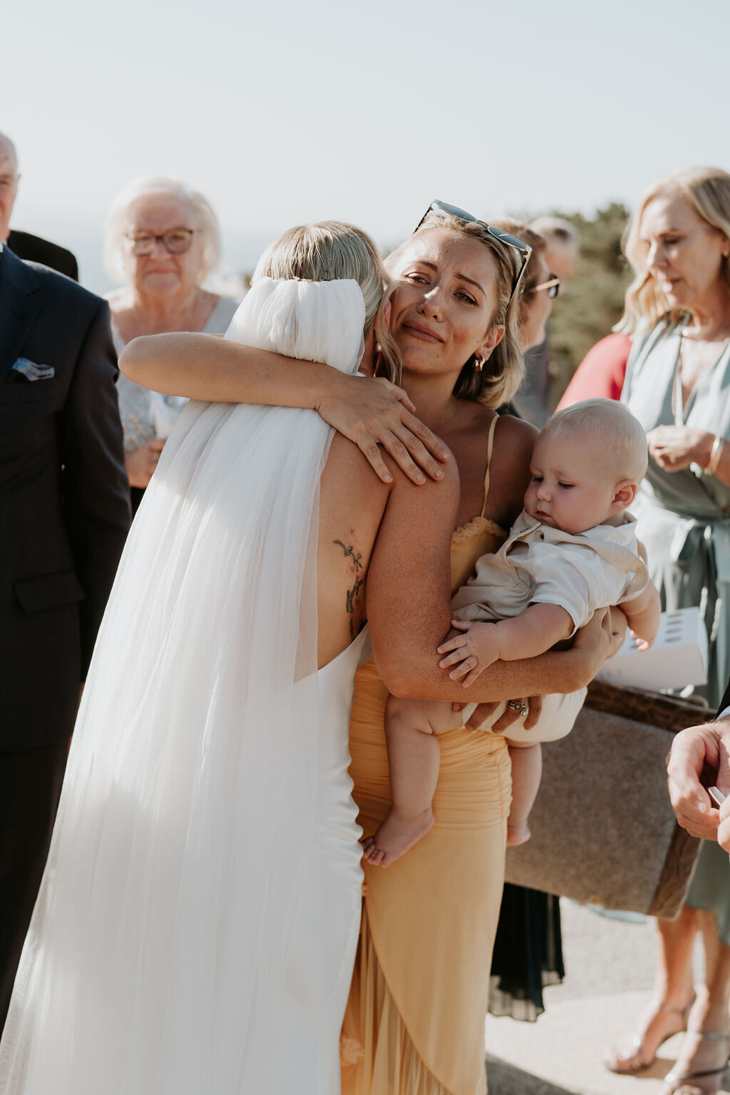 Sister hugging bride at Jack Rabbit Vineyard ceremony